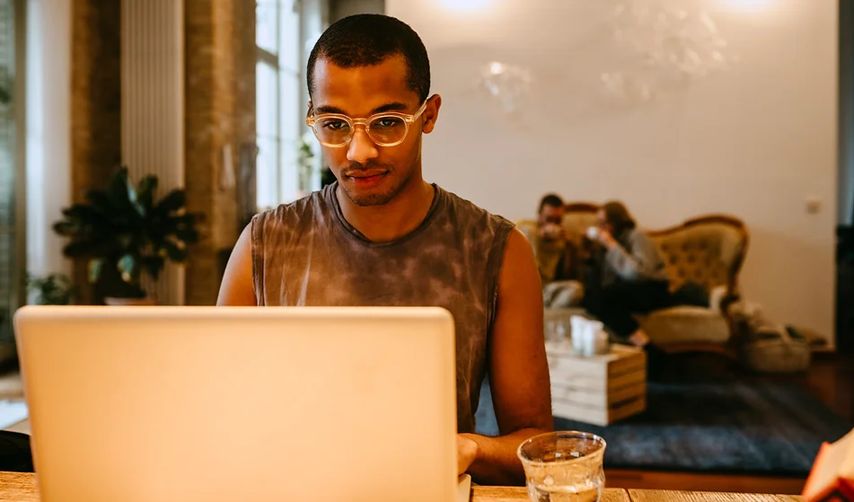 man working on laptop in a public setting